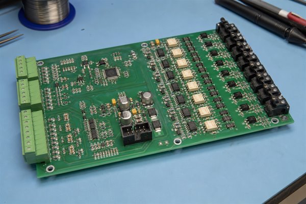 Mixed-signal control PCB with separate analog front-end and isolated digital input component regions