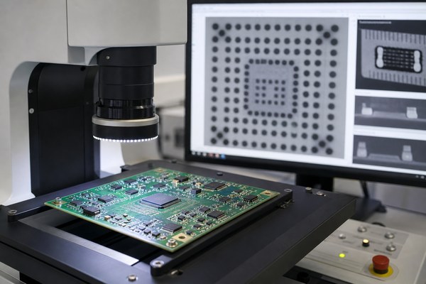 Automated optical inspection station examining an SMD PCB with X-ray images of hidden solder joints