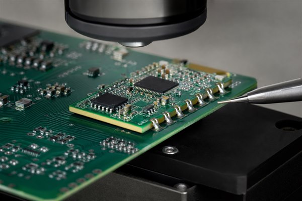 Castellated PCB, soldered module half-holes inspected on a carrier board