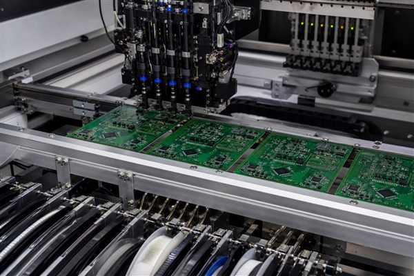 Generic laser diode driver PCBs moving through an electronics assembly line