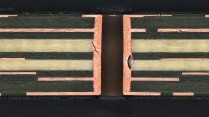 Illustrative PCB cross section showing a barrel crack and plating void for defect review
