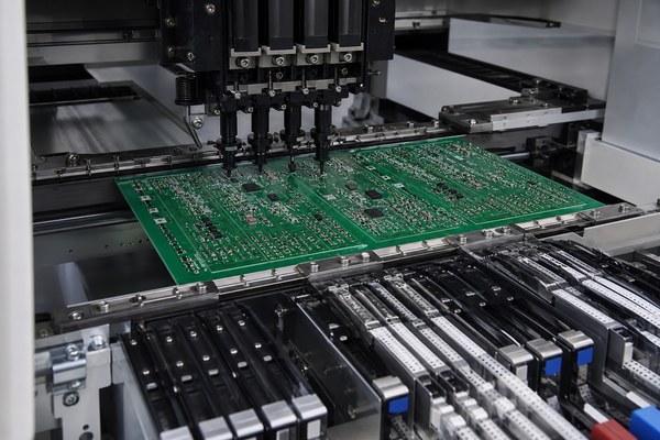 PCB Assembly Manufacturer in California, SMT placement equipment assembling a populated PCB panel