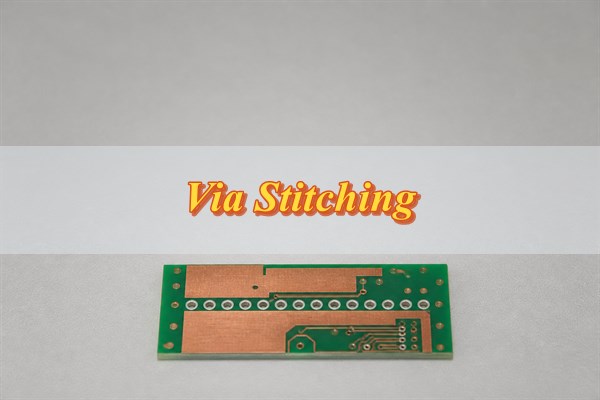 Via stitching test coupon with plated ground vias on a PCB inspection bench
