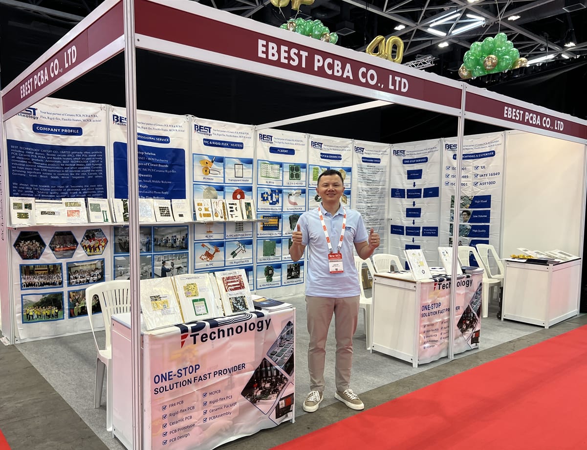 Our booth at a previous exhibition, with a team member and PCB product displays
